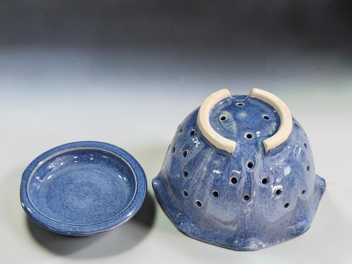 Blue ceramic berry bowl in a bright kitchen lifestyle setting