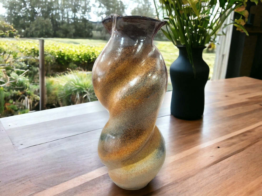 Unique Australian handmade pottery vase – experimental fluid form design on timber table