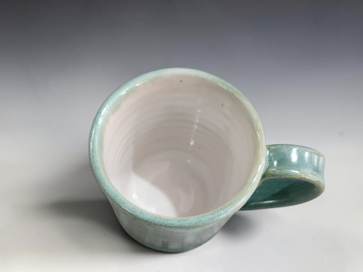 Soft green and blue mottled pottery cups holding approximately 100–120ml