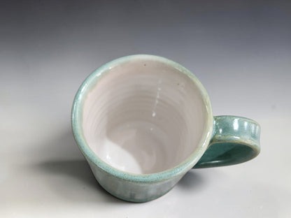 Soft green and blue mottled pottery cups holding approximately 100–120ml