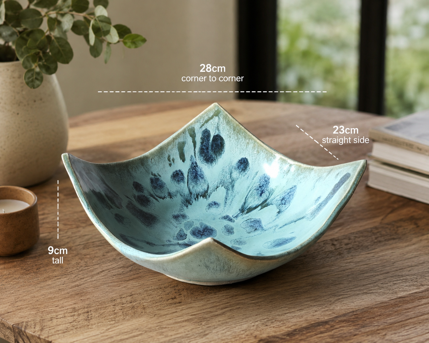 Hero image of artisan ceramic bowl styled on timber table with natural light and modern décor accents