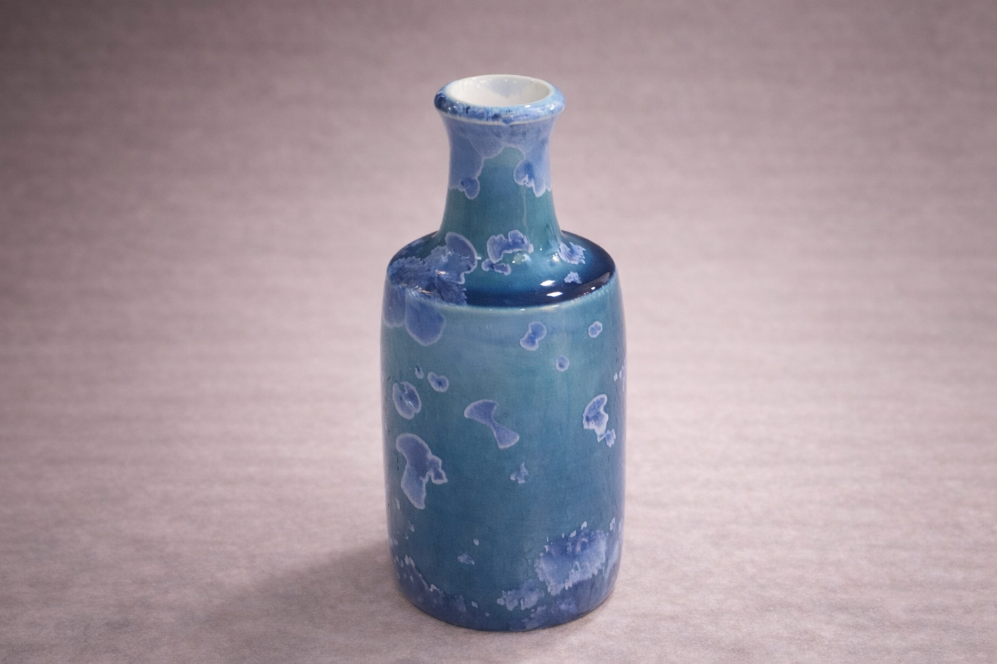 Tall ceramic bud vase with ocean blue glaze and pale crystal blooms, handmade in Melbourne