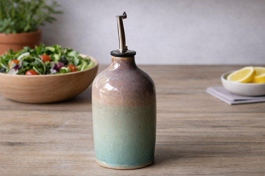 Handmade ceramic oil bottle with pour spout, ombre glaze on wood surface