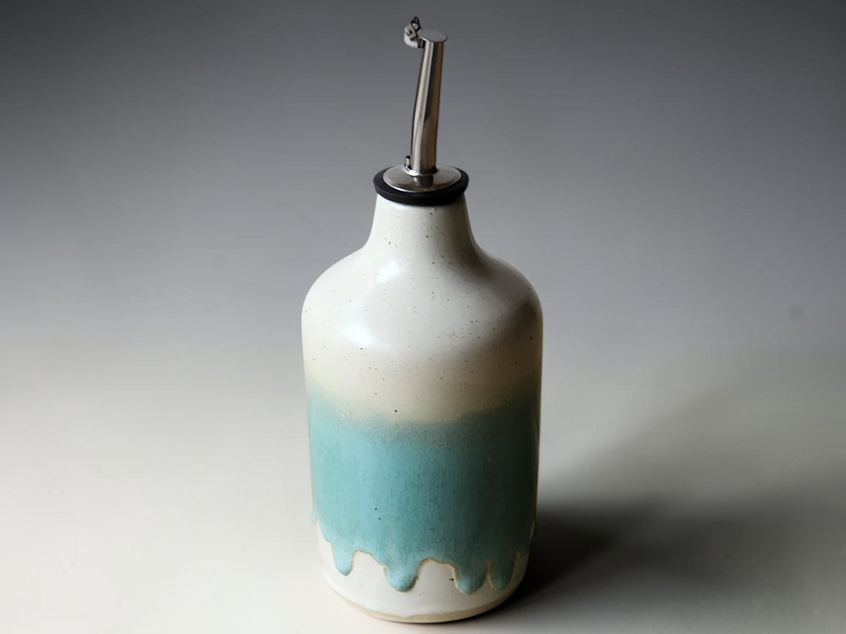 Green and cream glazed ceramic oil bottle with stainless steel pourer top