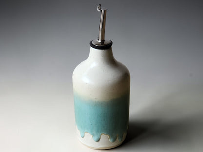 Green and cream glazed ceramic oil bottle with stainless steel pourer top