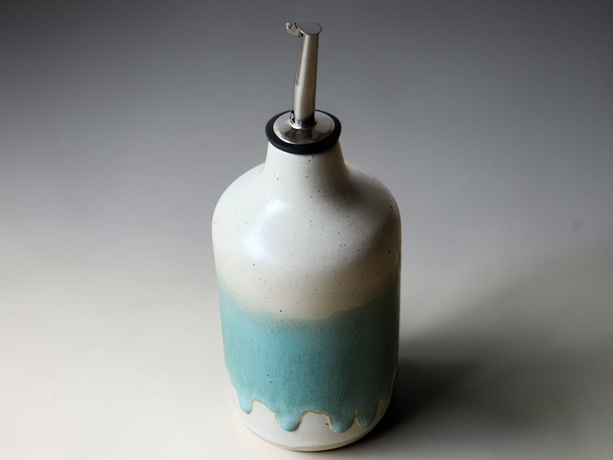 Handmade pottery oil cruet with drip glaze detail and metal pourer