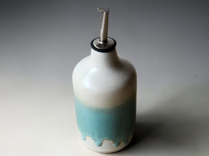 Handmade pottery oil cruet with drip glaze detail and metal pourer