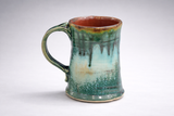 Handmade ceramic mug side view showing curved handle and green glaze detail, handmade pottery Melbourne Australia
