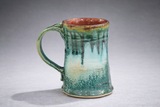 Handmade ceramic mug angled view highlighting glaze drips and speckling, handmade pottery mug Australia