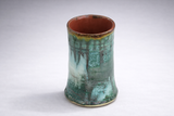 Handmade pottery mug front view with glossy green drip glaze and earthy rim, Melbourne Australia ceramics