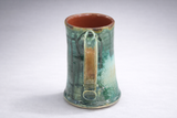 Handmade ceramic mug angled view highlighting glaze drips and speckling, handmade pottery mug Australia
