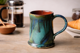 Handmade ceramic mug on wooden table with French press and croissant, Buxton Pottery Australia