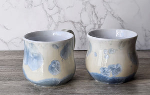 Ceramic mug with glossy white interior and blue crystal glaze