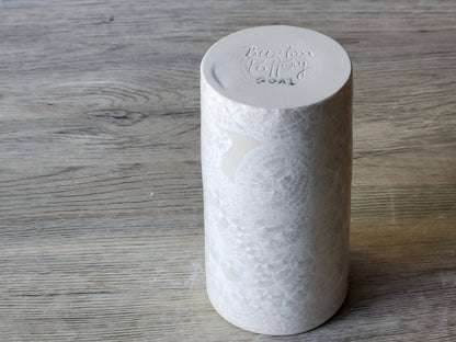 Under side of  a high-fired porcelain vase with glossy white crystalline glaze
