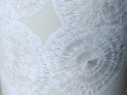 Close up of rings on the fathery crystals on a One-of-a-kind crystalline pottery tumbler – white porcelain vase