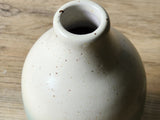 Neck opening in speckled cream glaze on a ceramic oil bottle