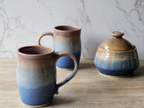 Unique handmade mug with layered blue and brown tones