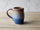 Comfortable handmade ceramic mug for tea or coffee in blue and brown