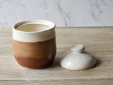 Lid off of the Handmade tall ceramic lidded jar – speckled cream and red-brown glaze – glossy brown interior – 13cm height – made in Melbourne