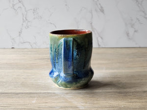 Handmade blue and green ceramic mug with ash glaze drips