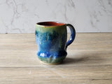 Handmade blue and green ceramic mug with ash glaze drips