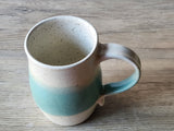 Speckled cream and green pottery cup