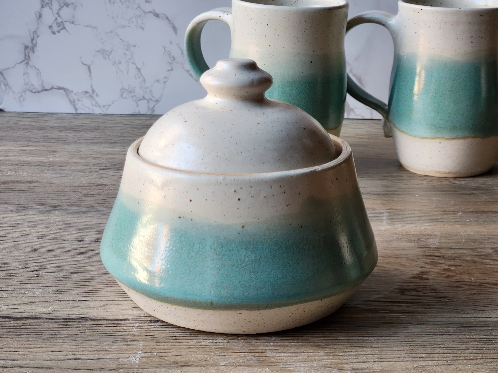 Sugar bowl Glazed in soft mottled green and satin buttermilk