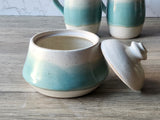 Wheel-thrown handmade pottery sugar bowl in cream and green.