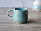 Melbourne-made small  handmade pottery mug in coastal green glaze with curved handle