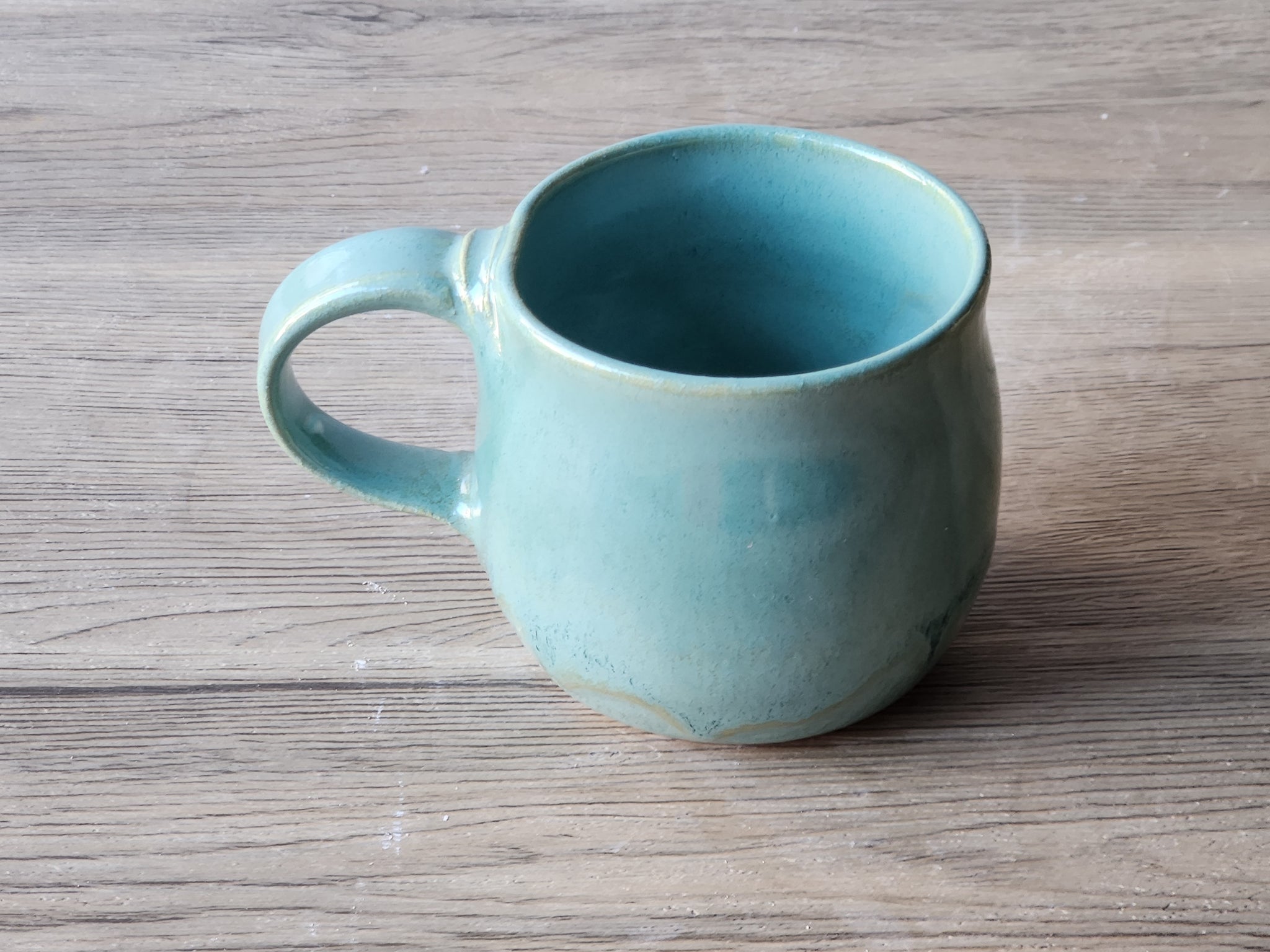  top view of Handmade ceramic mug with glossy turquoise glaze, made in Melbourne