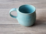  top view of Handmade ceramic mug with glossy turquoise glaze, made in Melbourne