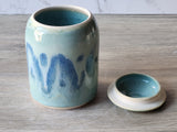 Ceramic container with blue patterns on a wooden surface