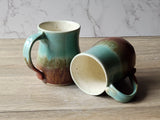 Handmade Artisan ceramic mug with turquoise top and red-brown base