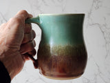 Handmade pottery coffee mug with speckled cream interior