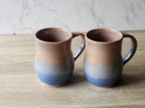 Large ceramic mug with glossy brown interior and blue base
