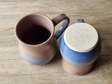 Rustic handmade mug with earthy brown and sky blue tones