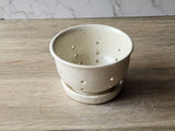 Wheel-thrown speckled cream ceramic bowl with drip tray