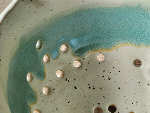 Close up of glaze on the Artisan pottery colander for rinsing berries and small fruit