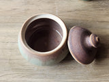 Handmade pottery jar with lid, perfect for home chefs