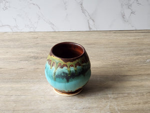 Wheel-thrown pottery tea cup with layered rustic glazes
