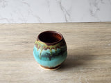 Wheel-thrown pottery tea cup with layered rustic glazes