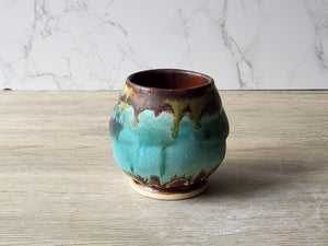 Unique pottery tea cup with mottled turquoise and moss green glazes
