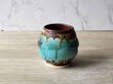 Unique pottery tea cup with mottled turquoise and moss green glazes