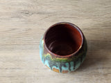 inside look at the burgandy glaze in the Handmade ceramic yunomi cup with earthy brown and green