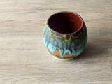 Wheel-thrown yunomi pottery cup in moss green and turquoise
