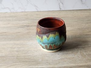 Handmade ceramic whisky sipper with earthy brown and green
