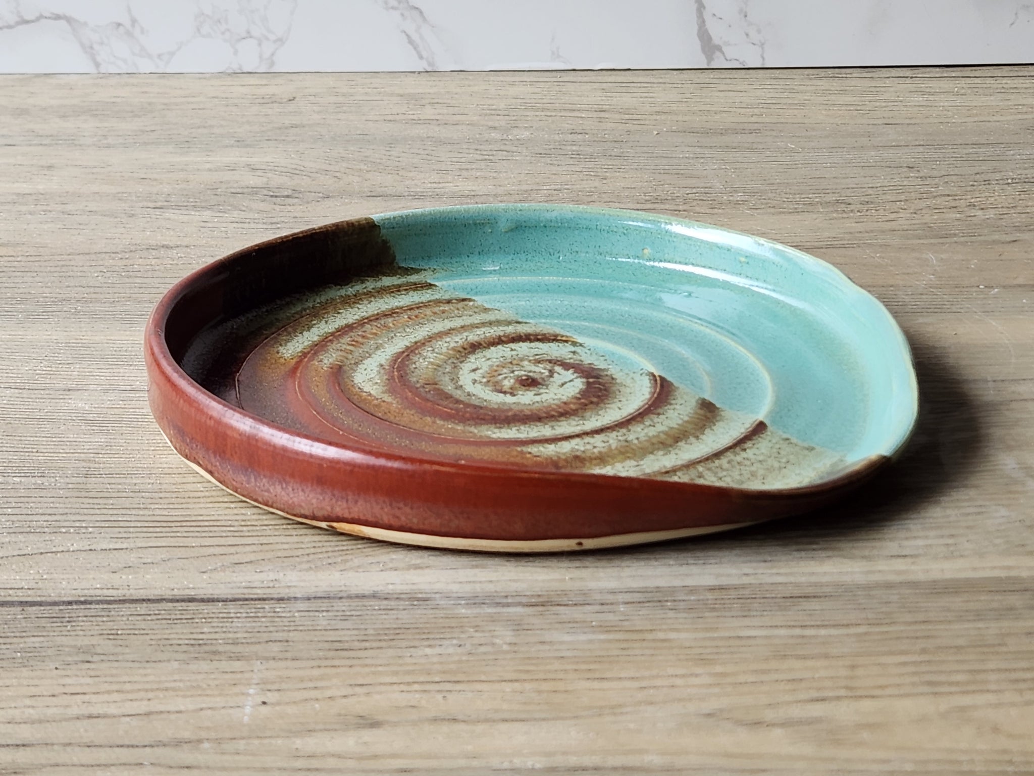 Extra-large handmade pottery spoon rest with green and red glaze