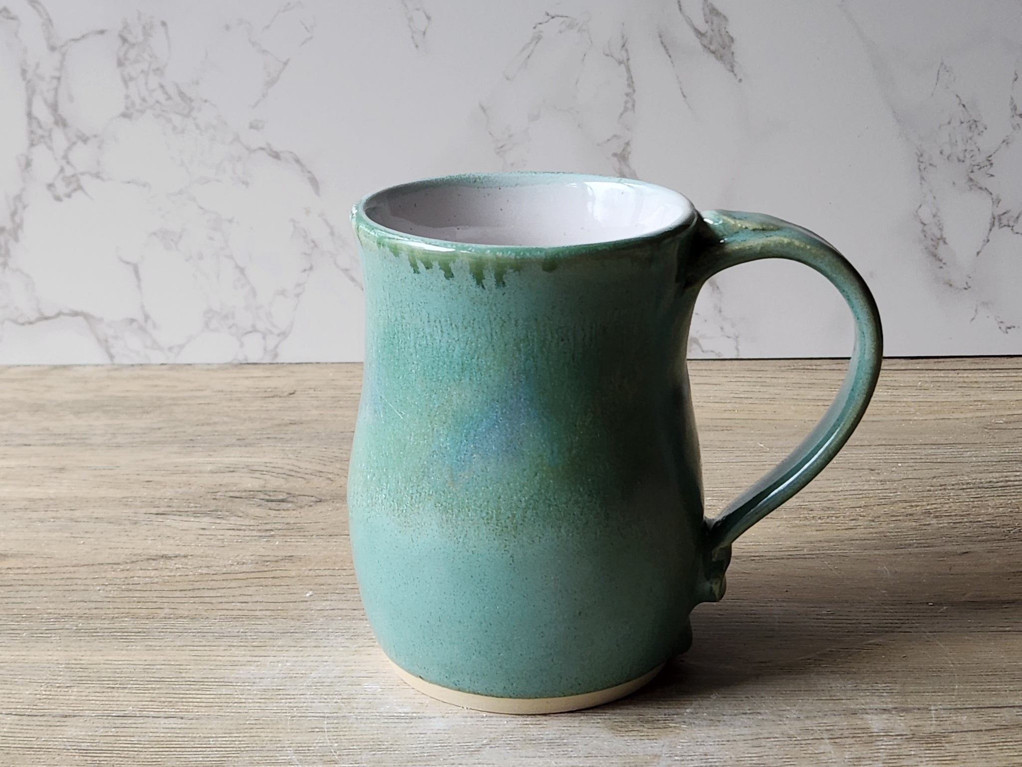 Large handmade ceramic mug in mottled soft green glaze made in Australia.
