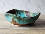 Wheel-thrown ceramic bowl altered with carving and coiling