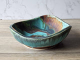 Artisan pottery serving dish with layered glazes